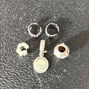 Pandora Gold Jewelry Silver and Gold charms.
3 spacers, 1 plumeria pink charm.